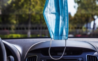 mask hanging in car from rearview mirro